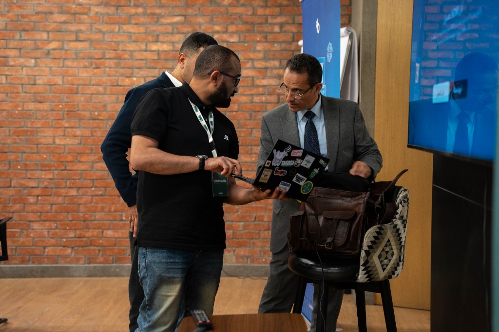 Dr. Hazem Halim discussing on laptop