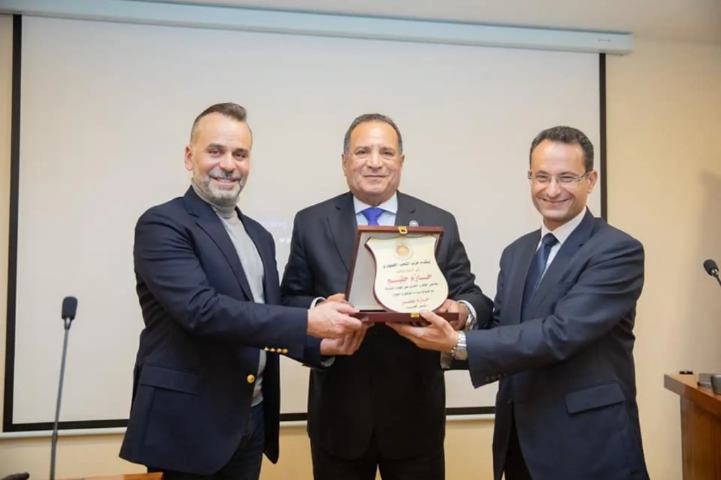 Dr. Hazem Halim receiving award shield
